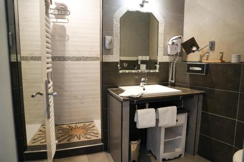 a bathroom with a sink and a shower at Domaine de l'Oustalia in Aix-en-Provence