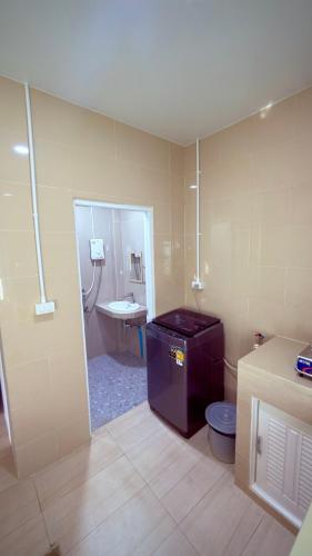 a bathroom with a sink and a toilet in it at The Little House in Chaloklum