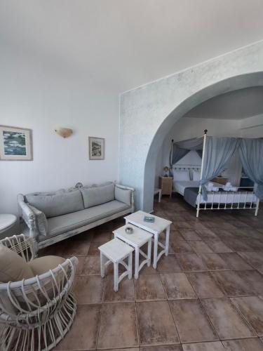 a living room with a couch and a bed at Solaris in Chora Folegandros