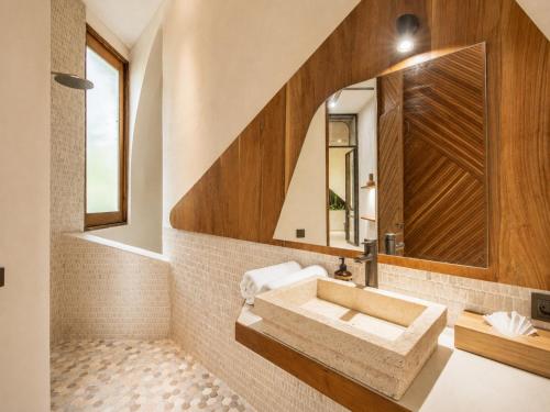 a bathroom with a sink and a mirror at Modern 1-BR Loft with Art Deco Style Shared Pool in Canggu
