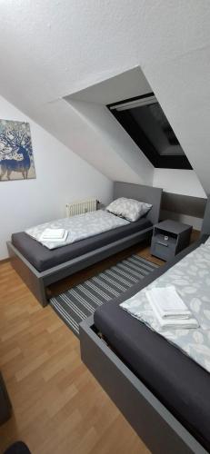 two beds in a room with a attic at Monteurwohnungwgapartment In 50129 in Bergheim