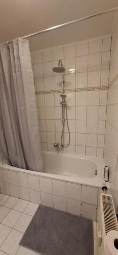 a bathroom with a bath tub with a shower at Monteurwohnungwgapartment In 50129 in Bergheim