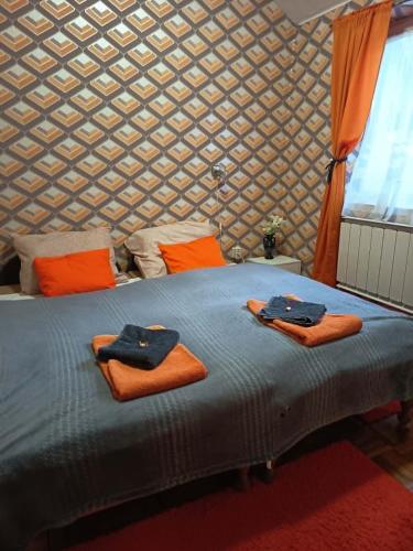 a bedroom with a bed with towels on it at Mathias Lovasudvar in Kemence
