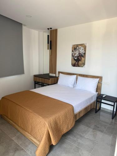 a bedroom with a large bed with two tables at IOLENA Two Bedroom SEAVIEW APT in Pyla