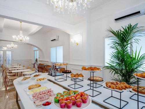 a buffet line with different types of food on display at B&B HOTEL Pesaro Des Bains in Pesaro