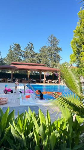 a swimming pool with people playing in the water at jasmine otel in Kemer