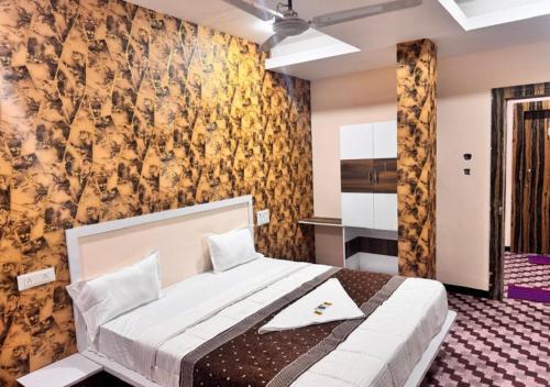 a bedroom with a large bed in a room at Shree ji Hotel and Resort in Ujjain