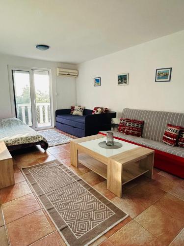 a living room with a couch and a coffee table at Reževići apartment Lav in Reževići