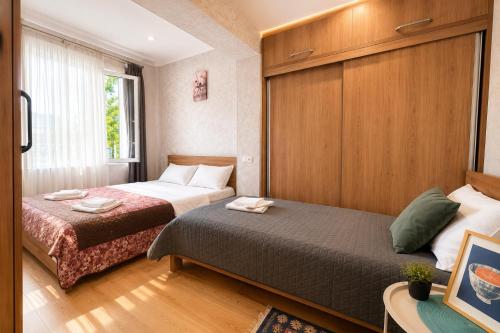 a hotel room with two beds and a window at Kitesa's apartment with two bedrooms in Mtskheta