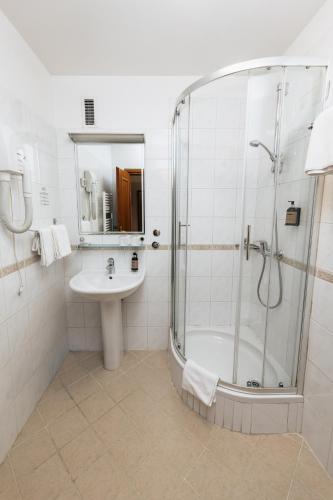 a bathroom with a shower and a sink at Hotel Lovran in Lovran