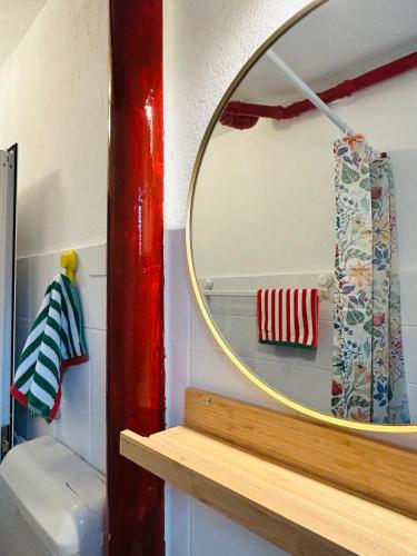 a mirror on top of a shelf in a bathroom at Reževići apartment Lav in Reževići