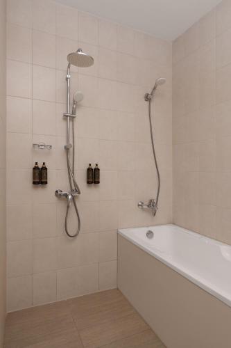 a bathroom with a bath tub and a shower at Ani Grand Hotel Yerevan in Yerevan