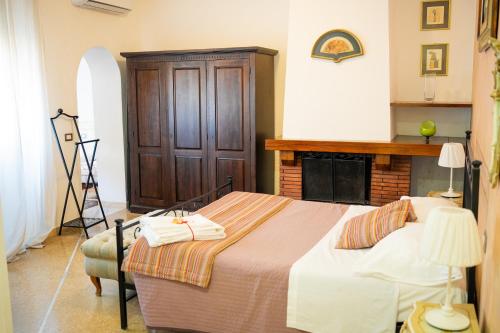 a bedroom with a bed and a fire place at Casamare Hotel in San Vincenzo