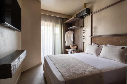 a hotel room with a bed and a window at Pournari Center Toroni in Toroni
