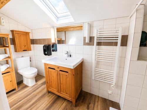 a bathroom with a sink and a toilet at Le Relais de la Calèche in Le Beausset