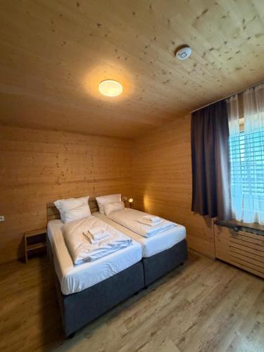 a bedroom with a bed in a wooden room at URBAN OAK Smart Stay in Cologne