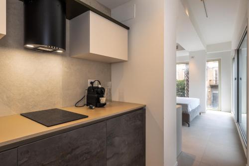a kitchen with a counter and a bed in a room at Suite 33 - Boutique Apartments in San Benedetto del Tronto