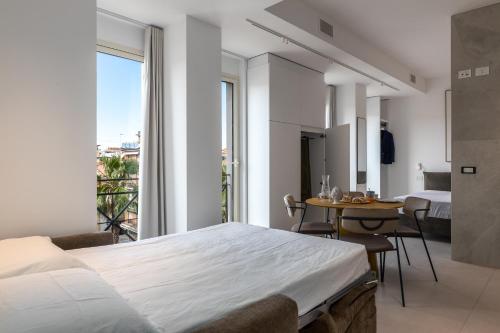 a bedroom with a bed and a table with chairs at Suite 33 - Boutique Apartments in San Benedetto del Tronto