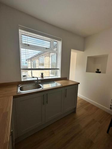 an empty kitchen with a sink and a window at Spacious Two Bed House With Stunning View. in Paull