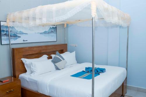 a bedroom with two beds with a canopy at The New Taiwan Hotel in Nyanhemwa