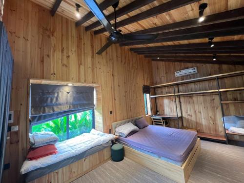 a room with a bed and an aquarium in it at Rao Retreat in Ấp Xuân Khai