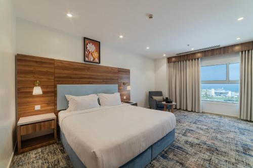a hotel room with a large bed and a window at Sidra Serviced Apartments - سدرا للشقق المخدومة in Al Khobar