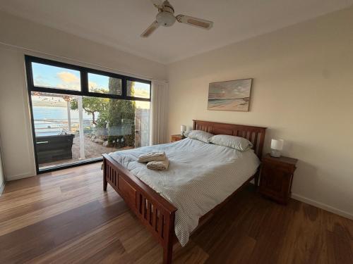 a bedroom with a bed and a large window at The Panorama On Earl in Albany