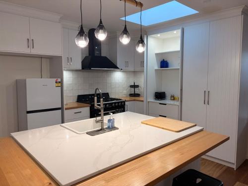a kitchen with a white counter top and a refrigerator at The Panorama On Earl in Albany