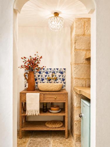 a room with a table with a vase on it at Pètra Boutique Home by Symphonya Luxury Holiday Rentals in Scorrano