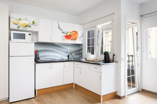 a kitchen with white cabinets and a sink at Maoli A Central Studio Icod de los Vinos in Icod de los Vinos