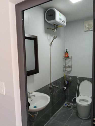 a bathroom with a white toilet and a sink at Phú Hưng Gia Motel in Ðức Hòa