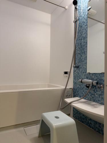 a bathroom with a toilet and a sink at WUMETEI Japanese-style lodge in Kyoto