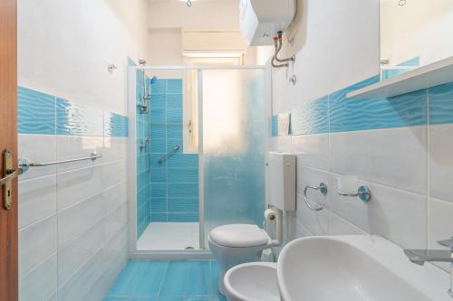 a bathroom with a shower and a toilet and a sink at Villa Preside in Noto Marina