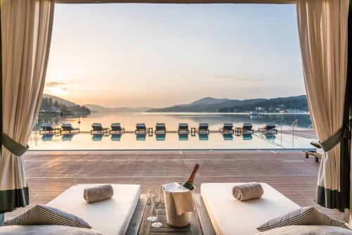 a hotel room with a view of the water at Falkensteiner Schlosshotel Velden – The Leading Hotels of the World in Velden am Wörthersee