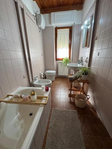 a bathroom with a tub and a toilet and a sink at Luna e Sentidu in Villaputzu