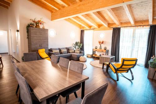 a living room with a wooden table and chairs at Haus Tauernblick am Katschberg in Katschberghöhe