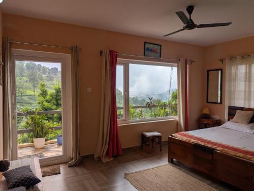 a bedroom with a bed and a large window at Moonlight Chillers By LexStays in Yedapalli
