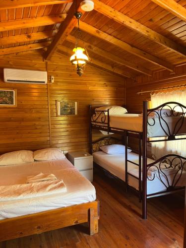 a bedroom with two bunk beds in a cabin at arzum bungalovs in Kumluca