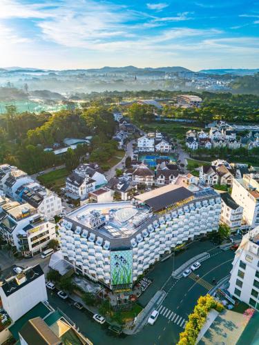 an aerial view of a city with a building at Nesta Valley Dalat Hotel - Formerly Golf Valley Hotel in Da Lat