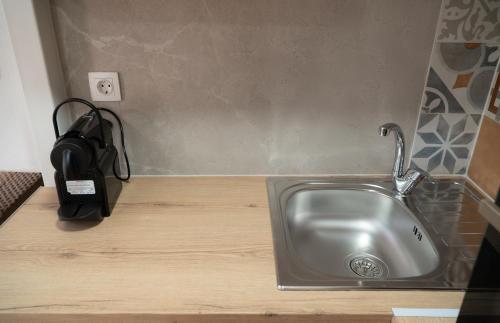 a kitchen with a sink and a phone on a counter at Christie's Home Meteora in Kalabaka