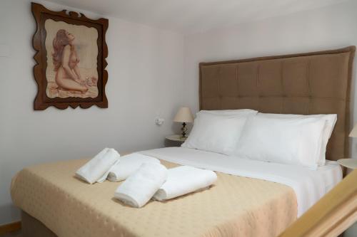 a bedroom with a bed with towels on it at Christie's Home Meteora in Kalabaka