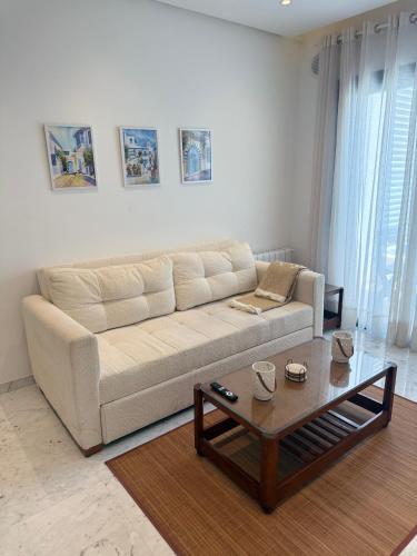 a living room with a couch and a coffee table at Breeze La Marsa in Tunis