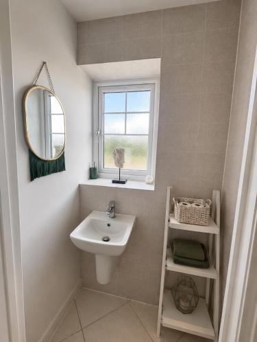 a bathroom with a sink and a window at Mason Gardens Home in Chilton