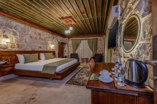 a bedroom with a bed and a table in a room at Latona Stone Palace in Göreme
