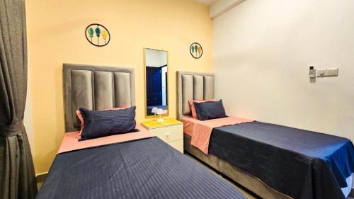 a room with two beds and a mirror at Inverse Travels in Negombo