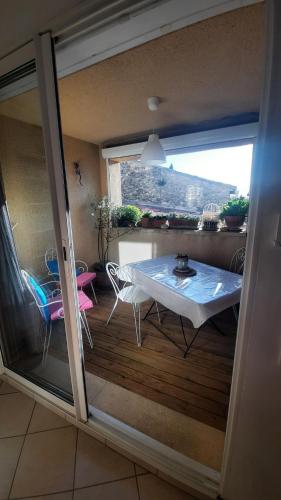 a view of a room with a table and a window at Chambre "Là Maison Haute" in Faucon