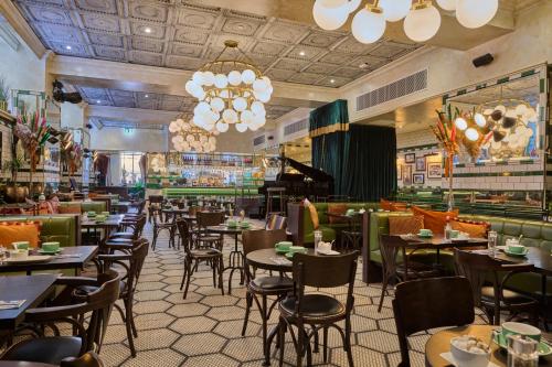 a restaurant with tables and chairs and a bar at The Grand Hotel Birmingham in Birmingham