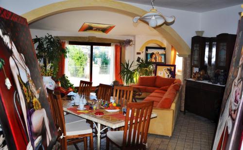 a living room with a table and a couch at Casa d' Artista B&B in Ozieri