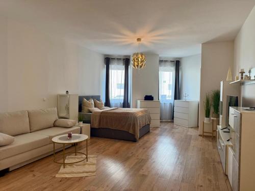 a living room with a bed and a couch at Excelsior in Graz