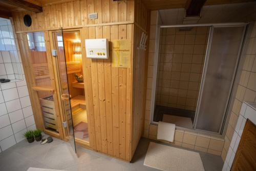 a small bathroom with a shower and a toilet at Frein Chalets - Kaltenbach in Frein